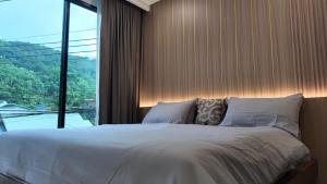 a bedroom with a large bed and a large window at Zoha 2BR Private Pool Villa Bangtao in Thalang +61 photos