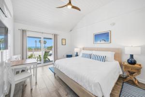 a bedroom with a bed and a desk and a window at Inn on the Beach in St. Pete Beach