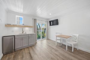 a kitchen with a sink and a table at Inn on the Beach in St. Pete Beach