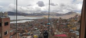 a view of a city with a river and buildings at Hospedaje wisny in in Puno