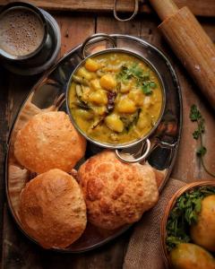 a plate of food with a bowl of soup and biscuits at Bholenath Guest House 500 Mitter From Shree Ram Manidr in Faizābād