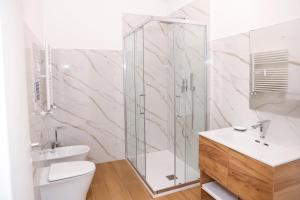 a bathroom with a shower and a toilet and a sink at Nina Guest house in Gaeta
