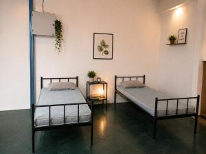 two beds sitting in a room with at F1 Riverside Mee Udang in Malacca