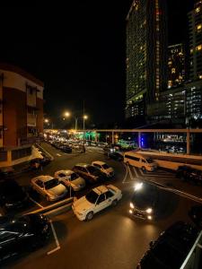 a group of cars parked in a parking lot at night at F1 Riverside Mee Udang in Malacca