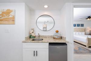 a white kitchen with a sink and a bedroom at Wind Drift 310S condo in Orange Beach +62 photos