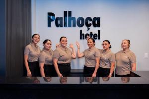 a group of people standing in front of a table at Palhoça Hotel in Canindé