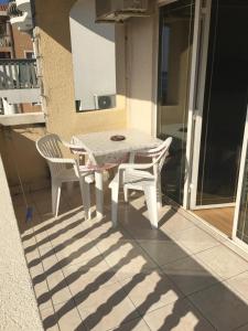 a white table and two chairs on a patio at Apartments and Rooms Villa Gaga 3 in Budva