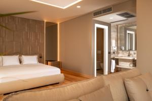 a bedroom with a bed and a couch at Kraal Hotel Vlore in Vlorë