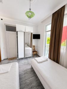 a bedroom with two beds and a mirror at Beliy Dom in Kvariati