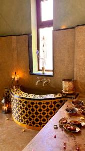 a large bathroom with a large tub with a window at Daba Riads in Marrakesh +56 photos