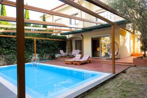 a swimming pool in the backyard of a house at Pool and Spa Retreat Villa in Tirana +81 photos