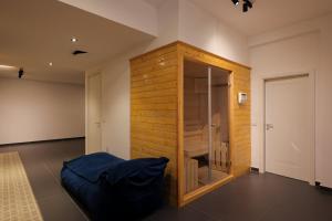 a room with a wooden wall with a bed in it at Pool and Spa Retreat Villa in Tirana