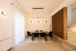a dining room with a table and chairs at Pool and Spa Retreat Villa in Tirana