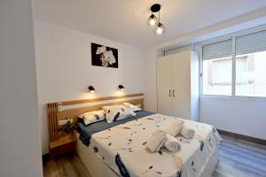 a bedroom with a large bed with towels on it at LEMON GARDEN Playa in Puerto de Sagunto +93 photos