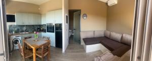 a kitchen and living room with a couch and a table at Karya View 2 in Kariá
