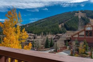 a view from a balcony of a town with a clock at Copper Springs Lodge 301 in Copper Mountain
