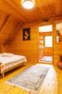 a bedroom with a bed in a wooden room at La VILLA DU REVE in Ulcinj +61 photos