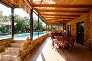 a patio with a table and chairs and a pool at La VILLA DU REVE in Ulcinj