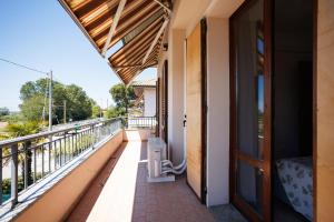a balcony of a house with a door at Casa Stella Marina in Cervia