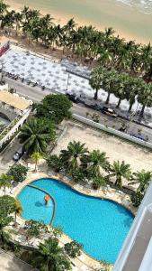 an overhead view of a pool with palm trees and a beach at View Talay 7 Seaview Apartments in Pattaya South +94 photos