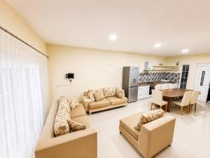 a living room with two couches and a table at DreamStay Lezha - Villa in Shëngjin