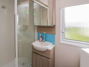 a bathroom with a sink and a shower at Craig Tara Holiday Park 101 Bay View in Ayr +11 photos
