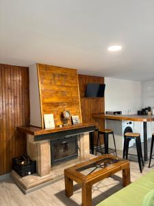 a living room with a fireplace and a table at El Rincón De Tere in Riaza
