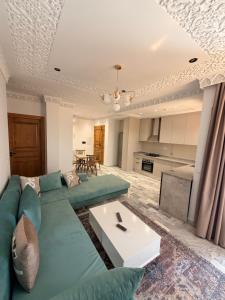 a living room with a couch and a table at Dar Carthage Hergla in Harqalah