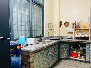 a kitchen with a sink and a counter top at KyNa House in Rạch Giá