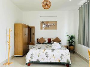 a bedroom with a bed in a room at KyNa House in Rạch Giá