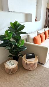 a living room with a couch and a plant at View Talay 7 Seaview Apartments in Pattaya South