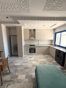 a large kitchen with a table in the middle at Dar Carthage Hergla in Harqalah