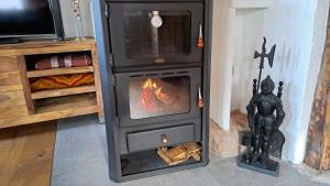 a stove in a room with a fire in it at Ferienhaus Rita in Bad Bocklet +16 photos