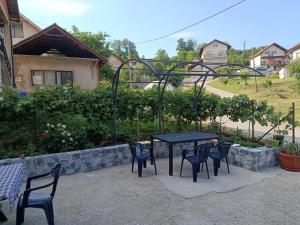 a black table and chairs in a patio at Kuća - Šekovići in Šekovići