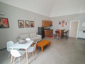 a living room with a couch and a table and chairs at Casa Mario in San Severo