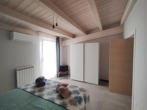 a bedroom with a bed and a large window at Casa Mario in San Severo