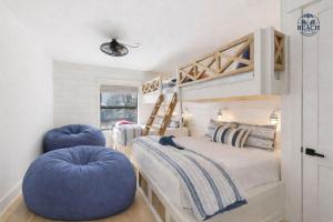 a bedroom with a bunk bed and two blue chairs at Beach,Please in Rosemary Beach +90 photos