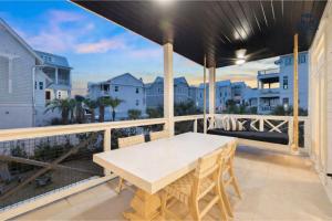 a table on a balcony with a view of the ocean at Beach,Please in Rosemary Beach