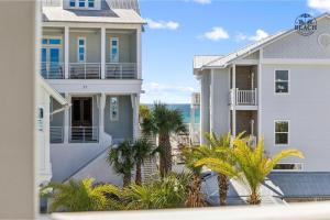 a large white house with palm trees in front of it at Beach,Please in Rosemary Beach