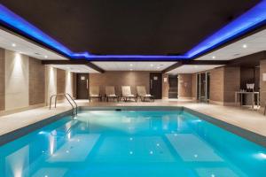 a swimming pool in a hotel with blue lights at Radisson Blu Hotel, Edinburgh City Centre in Edinburgh