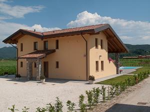 a small house with a pool in front of it at Agriturismo Luis Gianni in Cividale del Friuli
