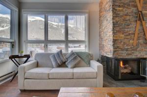 a living room with a couch and a fireplace at Woods12 Townhome Pet Friendly in Copper Mountain
