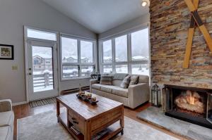 a living room with a couch and a fireplace at Woods12 Townhome Pet Friendly in Copper Mountain