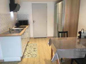 a kitchen with a sink and a counter top at Au Petit Paradis in Balan