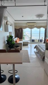a living room with a couch and a table at View Talay 7 Seaview Apartments in Pattaya South