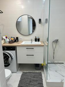 a bathroom with a sink and a shower at Смарт хаус in Yuzhne +9 photos