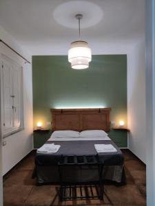 a bedroom with a bed in a green wall at Palazzo ReSilente- B&B dell'Infopoint in Castelnuovo Cilento +94 photos
