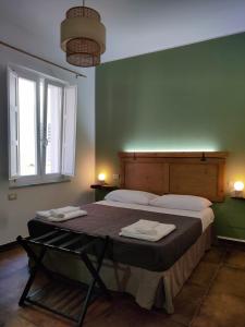 a bedroom with a bed with two towels on it at Palazzo ReSilente- B&B dell'Infopoint in Castelnuovo Cilento