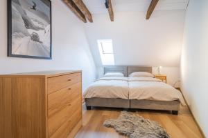 a bedroom with a bed and a wooden dresser at Apartmány Ski Telgárt - Telgárt Resort in Telgárt