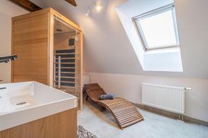 a bathroom with a sink and a skylight at Apartmány Ski Telgárt - Telgárt Resort in Telgárt